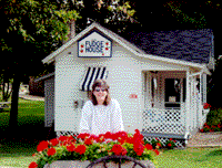 Kim in front of a fudgehouse